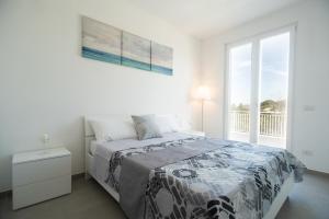 Un ou plusieurs lits dans un hébergement de l'établissement Rainone Resort - San Marco di Castellabate