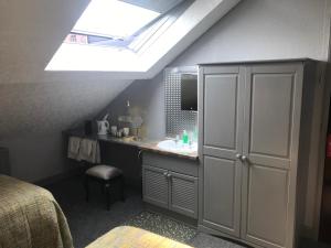 a bathroom with a sink and a skylight at Cornerways Guest House in Carlisle +44 photos