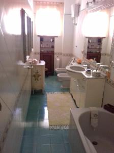 bagno con 2 servizi igienici, vasca e lavandino di Casa Meriva a Napoli