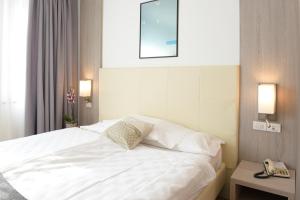 Postel nebo postele na pokoji v ubytování Hotel Venezia
