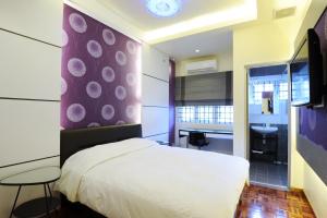 a bedroom with a white bed and a sink at The One Vacation Home in Malacca