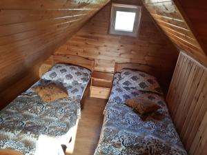 two beds in the attic of a log cabin at Tajek in Stegna