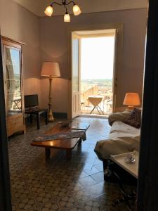 a living room with a couch and a table at Town View in Noto