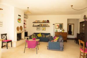 a living room with a couch and a table and chairs at Villa Buras in Skinária