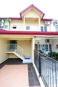 a house with a balcony and a gate at The One Vacation Home in Malacca