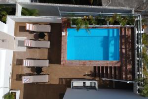 an overhead view of a swimming pool on a building at Arrecife Studios I Prime Location Steps to the Beach in Playa del Carmen