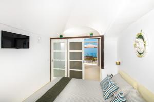 a bedroom with a bed and a sliding glass door at Maison Rosa in Positano