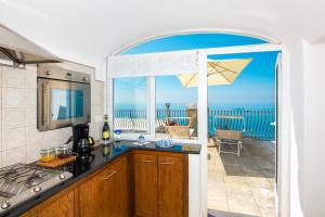 a kitchen with a view of the ocean at Maison Rosa in Positano