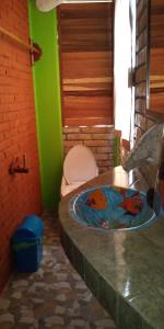 a bathroom with a toilet and a sink at Casa Gundi y Tomas in Puerto &Aacute;ngel