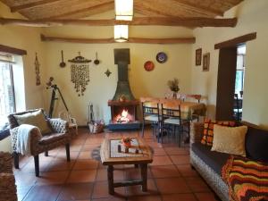 a living room with a couch and a fireplace at Hostal Apuwara in Combarbalá