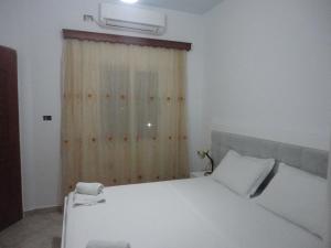 Postel nebo postele na pokoji v ubytování Oruci Apartments