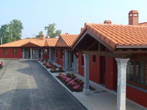 a row of red buildings with red roofs at Los Picos de Tereñes in Tereñes