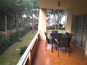 a patio with a table and chairs on a balcony at porta del golf in Pals