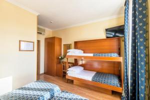 Postel nebo postele na pokoji v ubytování Hotel Tempio Di Pallade