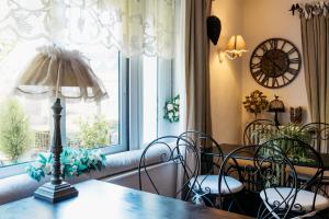 a dining room with a table and chairs and a window at Hôtel Boutique Saint-Louis in Lisieux