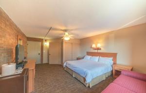 a hotel room with a bed and a couch at Mountain Chalet Snowmass in Snowmass Village