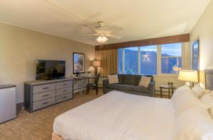 a hotel room with a bed and a television at Mountain Chalet Snowmass in Snowmass Village