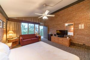 a bedroom with a large bed and a brick wall at Mountain Chalet Snowmass in Snowmass Village
