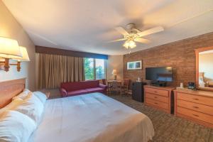 a hotel room with a bed and a television at Mountain Chalet Snowmass in Snowmass Village
