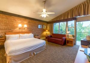 a hotel room with a bed and a couch at Mountain Chalet Snowmass in Snowmass Village
