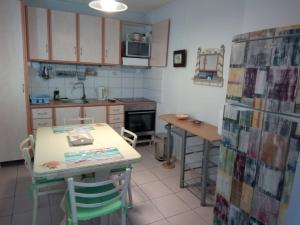 a kitchen with a table and a table and chairs at Cozy House in Argostoli in Argostoli