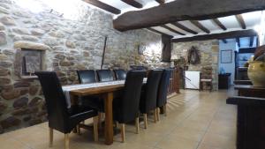 a dining room with a wooden table and black chairs at Maison d'hôtes de charme ttakoinenborda in Sare +13 photos