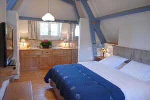 a bedroom with a large bed and a bathroom at Le Manoir du Rocher in Domme +69 photos