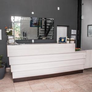 a white counter in a room with a mirror at Ch Loreto Hotel Boutique in Ciudad de Loreto