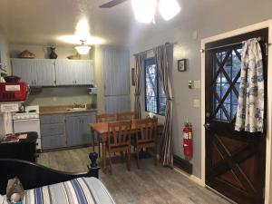 a kitchen with a wooden table and a wooden door at Ramsey Canyon B&B Apartment Suites in Nicksville
