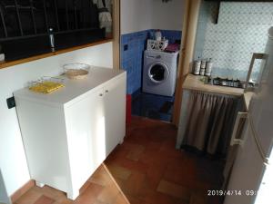 een kleine keuken met een wasmachine en een wasmachine bij La casetta in Terrasini +39 foto's