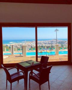 a dining room table with chairs and a window at Residence Chiesiola in Vieste
