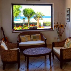 a living room with chairs and a large window at Residence Chiesiola in Vieste