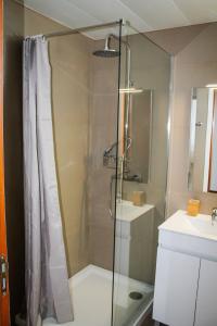 a shower with a glass door in a bathroom at The Best Atlantic Ocean View in Câmara de Lobos