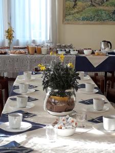a table with a vase with yellow flowers in it at Il Borgo dei Molini in Torreglia
