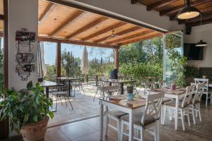 a restaurant with tables and chairs and a patio at Sky Apartments & Rooms in Cavtat
