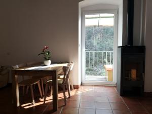 a dining room with a table and chairs and a window at Apartma Humar in Tolmin