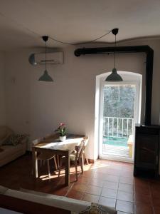 a living room with a table and a window at Apartma Humar in Tolmin