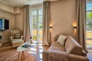a living room with a couch and a table at Parkside Apartments in Pula
