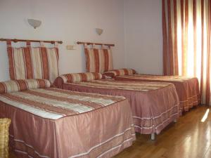 Postel nebo postele na pokoji v ubytování Hostal Triana