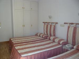 Postel nebo postele na pokoji v ubytování Hostal Triana