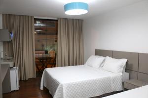 A bed or beds in a room at Transcar Suítes