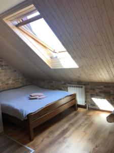 a bedroom with a bed in a attic with a window at U Lampy in Zakopane