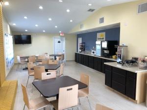 a restaurant with tables and chairs and a cafeteria at Days Inn by Wyndham King-Winston Salem Area in King