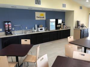 a restaurant with tables and chairs and a counter at Days Inn by Wyndham King-Winston Salem Area in King