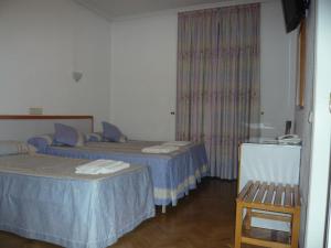 Postel nebo postele na pokoji v ubytování Hostal Triana