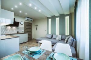 a living room with a couch and a table at Premium Apartman in Makó