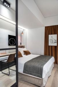 Postel nebo postele na pokoji v ubytování Niki Athens Hotel