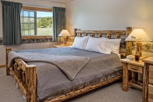 A bed or beds in a room at Stanley High Country Inn