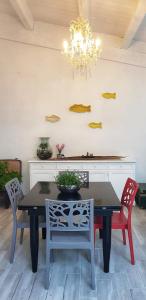 a dining room table with chairs and a chandelier at Da Giovanna a Marzamemi in Marzamemi +32 photos