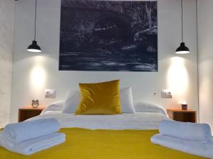 a bedroom with a bed with two pillows on it at VUT- La Deliciosa in Sotillo de la Adrada